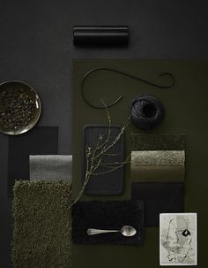 an assortment of items are displayed on a black surface with green and gray colors, including yarn, scissors, thread, and other materials