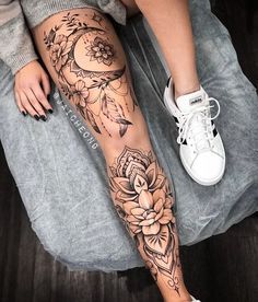 a woman's leg with flowers on it