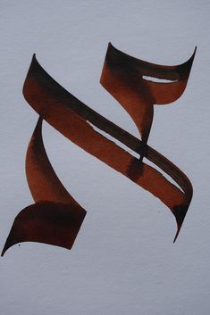 the letter s is made up of two curved strips of brown paint on white paper