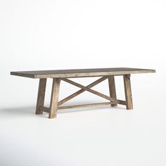 a wooden table sitting on top of a white floor