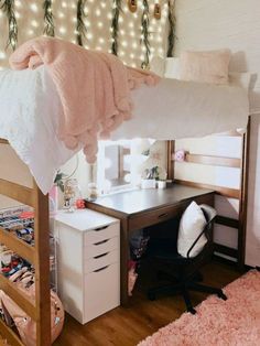 a loft bed with a desk underneath it and lots of lights on the wall behind it