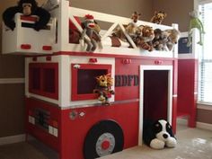 there is a fire truck bed with stuffed animals on top and ladders to the roof