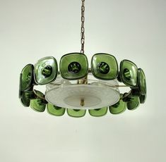 a green glass chandelier hanging from a chain