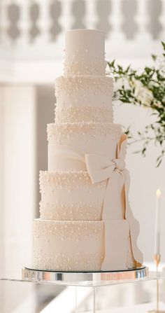 a white wedding cake sitting on top of a table