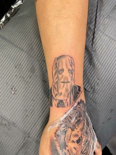 a man with a dog and cat tattoo on his arm