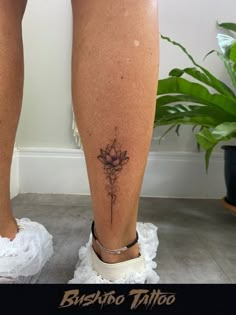 a woman's legs with a tattoo on the lower part of her leg and bottom half