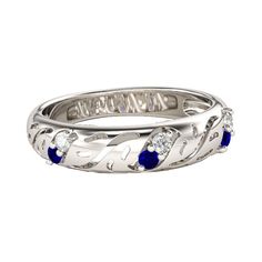 a white gold ring with blue sapphire stones and the word love written in cursive writing