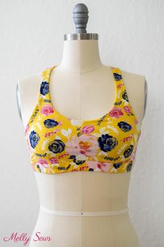 a female mannequin wearing a yellow and blue floral print bra with white straps