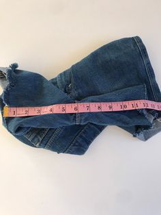 "Waist:26\" Rise:10.5\" Hips:32\" Inseam:6\" These are USA made Movin' On Levis zip fly cutoffs circa the late 70's or early 80's. They're tagged a vintage 28\" but fit a modern 26\" at largest. Please follow the measurements provided above and in the photos for an accurate fit as true vintage runs small and narrow. They're cut to the perfect unisex length and have amazing details on the pockets and feature a rare blue tab. 🍑(5)" Stretch Denim Jean Shorts With Frayed Hem, Stretch Cotton Jean Shorts With Frayed Hem, Mid-rise Fitted Jean Shorts With Frayed Hem, Fitted Mid-rise Jean Shorts With Frayed Hem, Stretch Jeans With Frayed Hem In Short Length, Vintage Jeans With Built-in Shorts For Spring, Stretch Denim Blue Jean Shorts With Frayed Hem, Distressed Stretch Jean Shorts For Spring, Stretch Denim Cutoff Jean Shorts