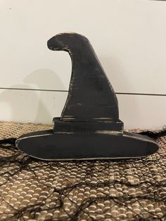 a wizard's hat sitting on top of a table next to a white wall