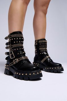 Tune into your rebellious side when you step out in The AZALEA WANG Winola Black Belted Bootie. These flatform faux leather booties feature a rounded square toe, a mid-calf shaft, a lace up vamp, faux gold metallic hardware, and a ridged platform sole with a coordinating chunky rubber heel, detailed with circular studded embellishments. Complete with a pull-on fit, a tonal inner ankle zipper closure, and stacked buckled belt detailing down the shaft, adorned with circular and spiked studded embellishments. Pair with a fitted corset top and a faux leather midi skirt for a finished look.  (all measurements are approximate from size 7.5) - Faux Leather Upper - Rounded Square Toe - Chunky Heel  - Platform Sole - Mid-Calf Shaft - 2.5” Heel Height - 1.25” Sole Height - 7.25” Shaft Height - Impor Knee High Lace Up Boots Outfit, Lace Up Boot Outfit, Faux Leather Midi Skirt, Azalea Wang, Black Platform Boots, Rounded Square, Platform Heels Chunky, Fabulous Shoes, Shoe Closet