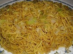 a plate with noodles and onions on it