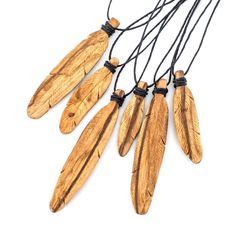 an assortment of wooden necklaces with black cord