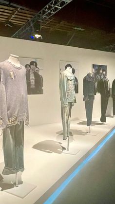 an exhibit with mannequins and jackets on display