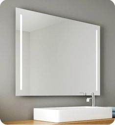 a white sink sitting under a mirror in a bathroom next to a wall mounted faucet