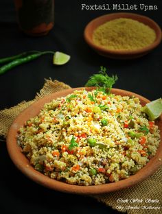 a bowl filled with rice and vegetables on top of a table