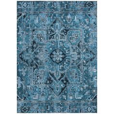 a blue rug with an intricate design on the front and back side, in different colors