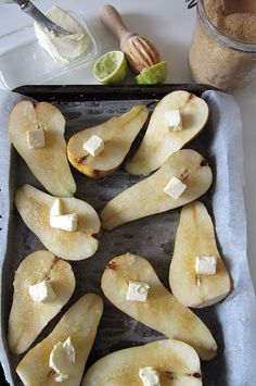 sliced pears on a baking sheet with butter and honey