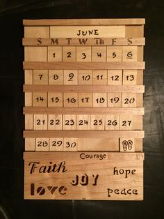 wooden calendars with names and dates displayed on a table in front of a black background