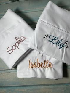 three personalized towels on top of each other