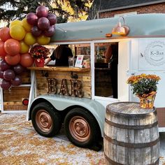 a food truck with balloons attached to it