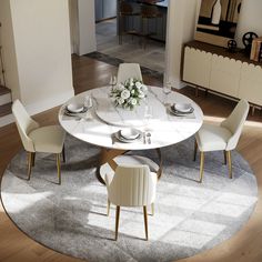 a dining room table with white chairs and flowers on it in front of a doorway