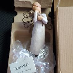 a ceramic figurine in a cardboard box with the label dempaco on it