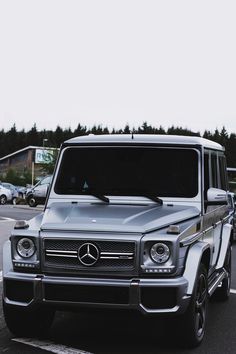 a mercedes g class parked in a parking lot