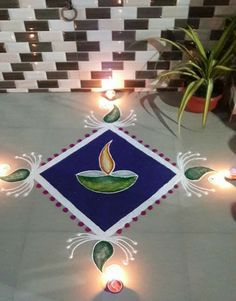 a decorated floor with candles on it and a potted plant in the corner next to it