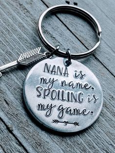 a keychain that says nana is my name, spoiling is my game