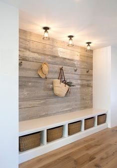 a wooden wall with baskets and lights on it