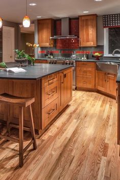 a large kitchen with wooden floors and cabinets