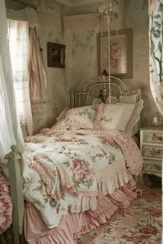 an old fashioned bedroom with pink flowers on the bedspread and canopy over the bed