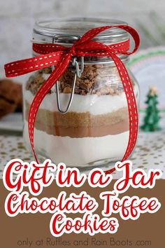 a jar filled with chocolate toffe cookies on top of a table