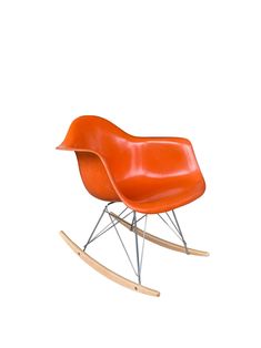 an orange rocking chair with metal legs and wooden slats on the bottom, against a white background