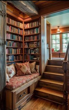 a room with stairs and bookshelves filled with books