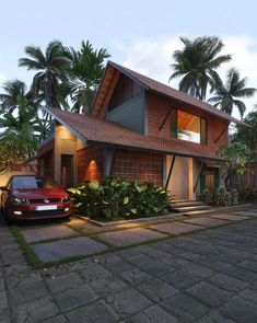 a car is parked in front of a house with palm trees on the side of it