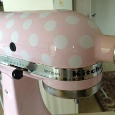 a pink mixer with white polka dots on it