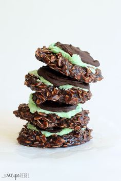 three cookies stacked on top of each other with green frosting and pecans in the middle