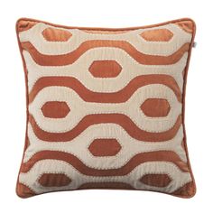 an orange and white pillow with circles on it