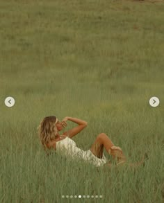 a woman laying in the middle of a field