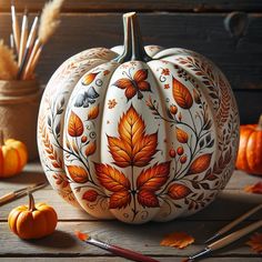 a painted pumpkin sitting on top of a wooden table