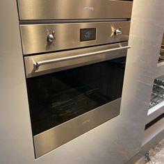 a stainless steel oven with the door open