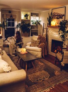 a living room filled with furniture and a fire place in the middle of the room