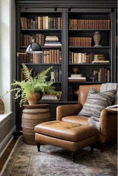 a chair and ottoman in front of a bookcase with books on the shelves behind it