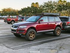 a red suv parked in a parking lot