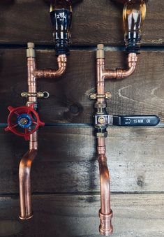 three copper pipes are connected to the wall