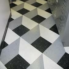 a black and white checkered floor next to a metal cabinet in a room with an open door