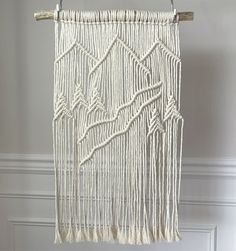 a white macrame hanging on a wall