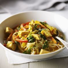 a white bowl filled with noodles and vegetables